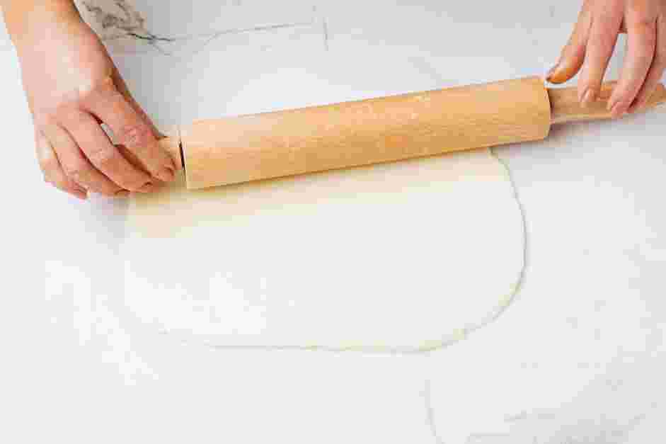 Potato Candy Recipe: Divide the dough in half and transfer half of the dough onto a large sheet of parchment paper.