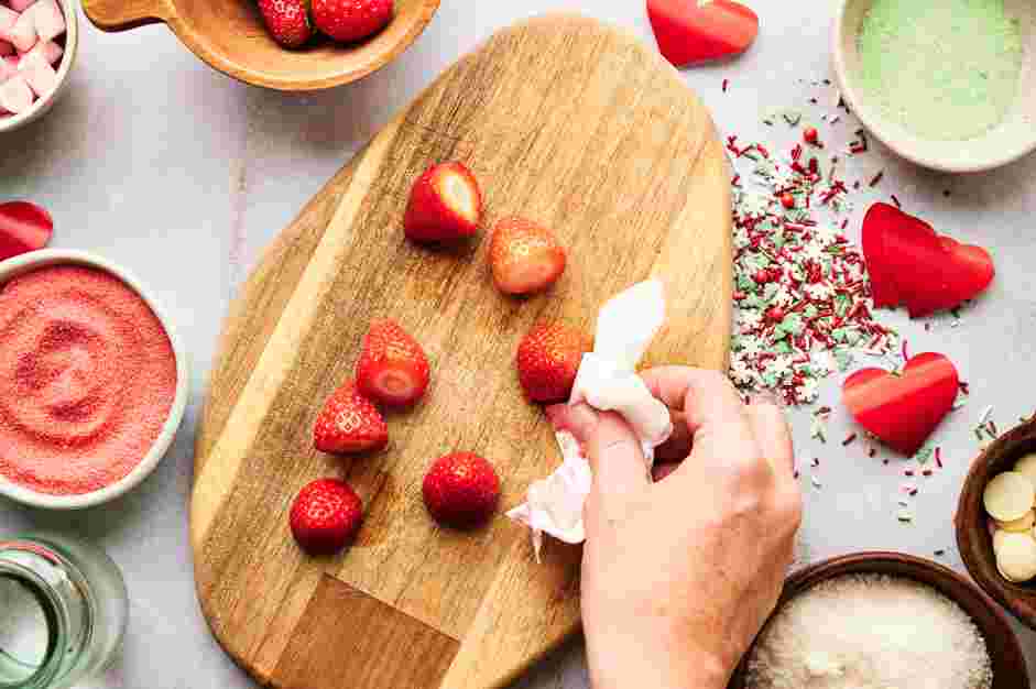 Grinch Punch Recipe: Prepare the strawberry Christmas hats.