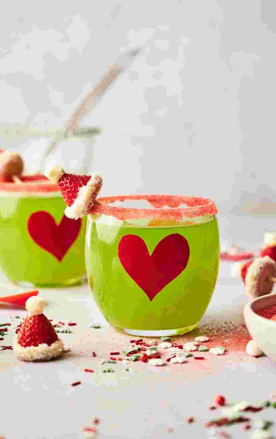 Grinch Punch Recipe: Decorate with a skewered strawberry Christmas hat.