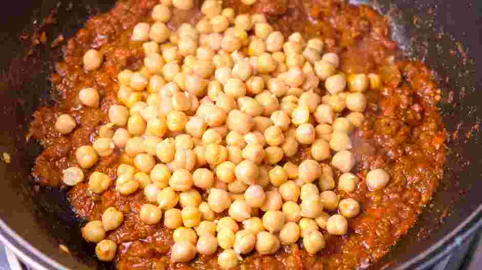 Coconut Curry Chickpeas Recipe: Add the drained and rinsed chickpeas and lime juice to the pan, stirring to combine them with the tomato and spice mixture.