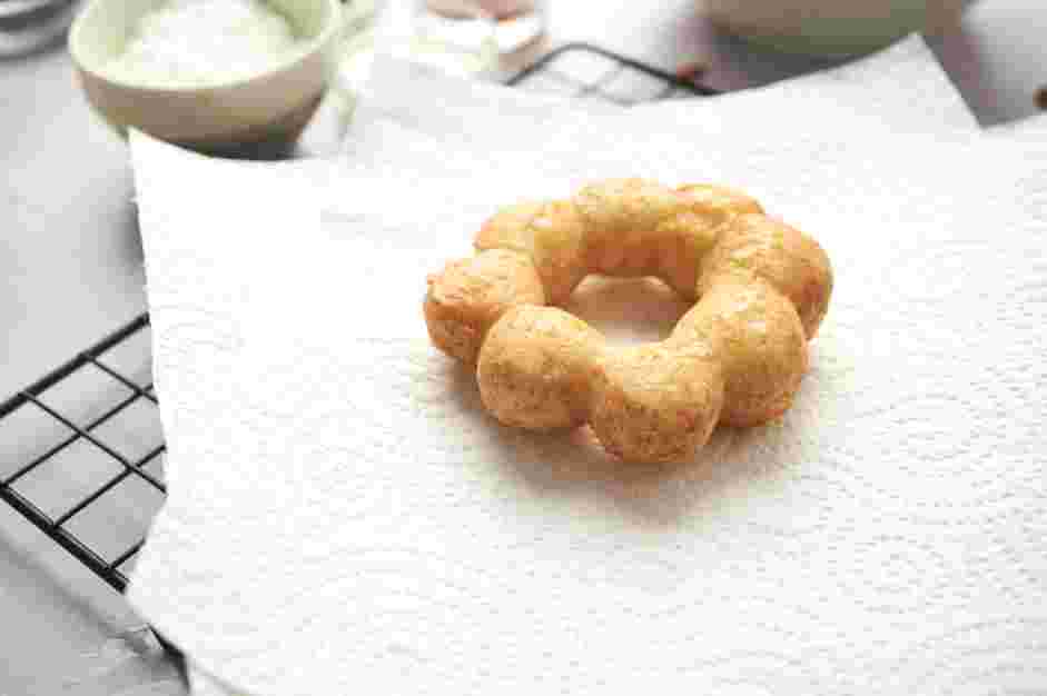 Mochi Donuts Recipe: Lift the fried donut from the oil, letting the excess drip off.