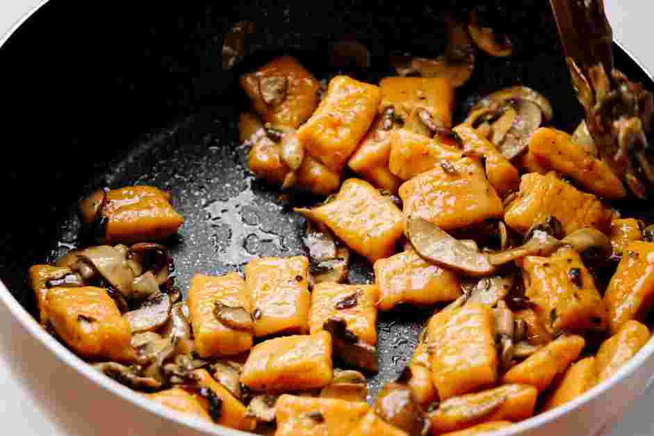 Sweet Potato Gnocchi with Mushroom and Pesto Sauce Recipe: Place a batch of cooked gnocchi into the reserved frying pan with the mushrooms.