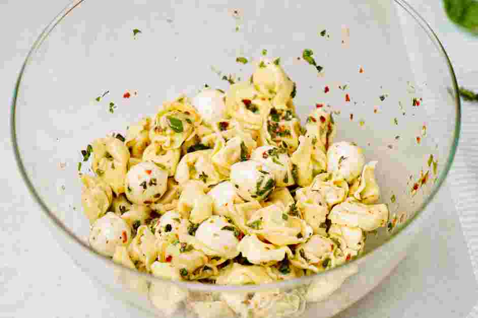 Antipasto Skewers Recipe: Add the tortellini pasta to the bowl with the marinade.