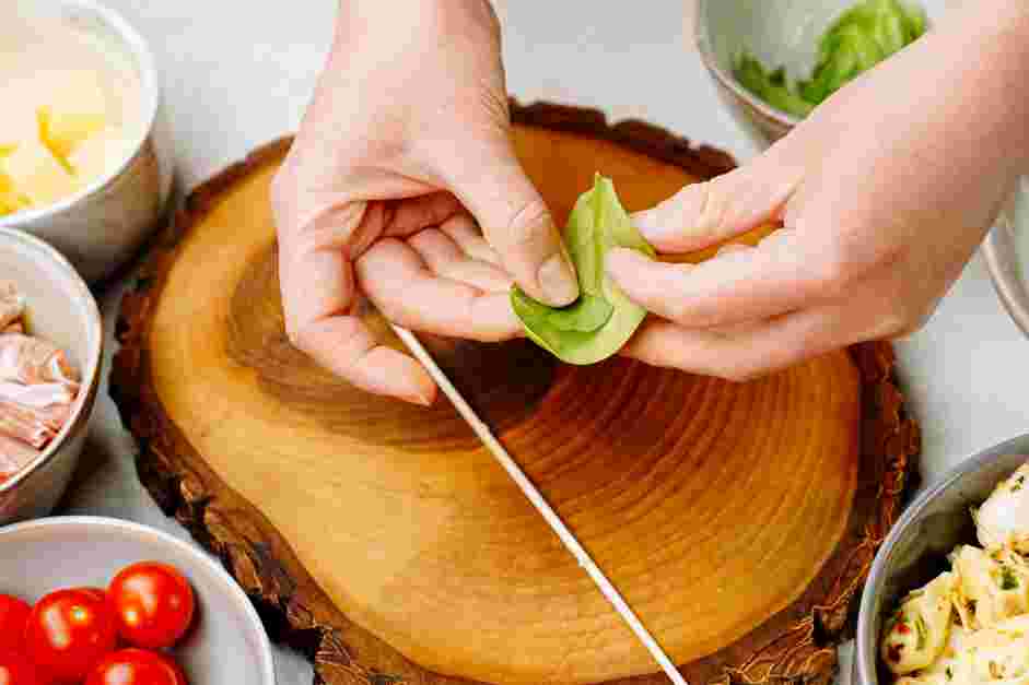 Antipasto Skewers Recipe: When threading the basil, place one halved basil leaf in between a baby spinach leaf.