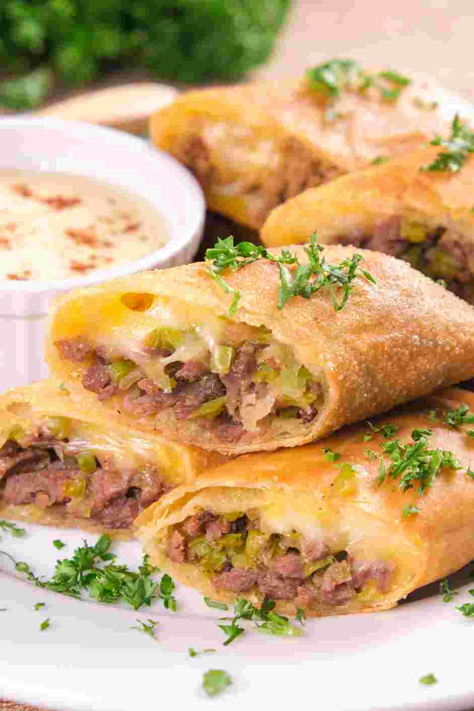 Philly Cheesesteak Egg Rolls Recipe: Serve whole or sliced in half diagonally with the provolone dipping sauce.