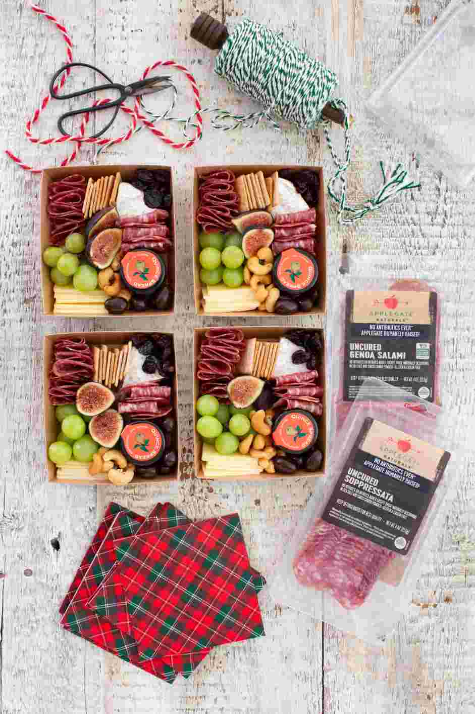 Mini Charcuterie Boxes Recipe: Spread mini charcuterie boxes on a table and encourage guests to take a box while they mix and mingle.