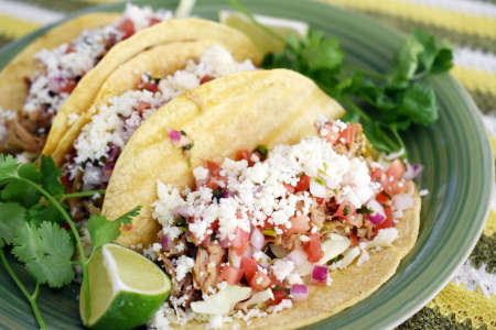 Chicken tinga tacos with pickled onions