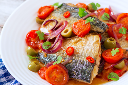 Mediterranean style grilled fish with tomato olives and capers