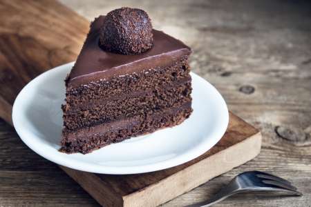 a piece of vegan chocolate ganache cake on a plate