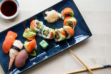 a variety of sushi rolls on a platter