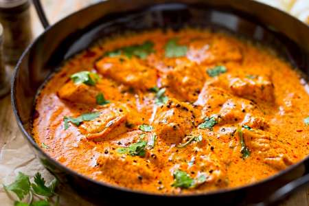 butter chicken in a black pan