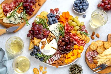 charcuterie board with cheese fruit cured meats and wine