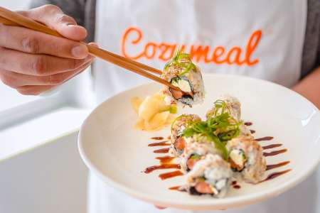 chef presenting salmon avocado roll