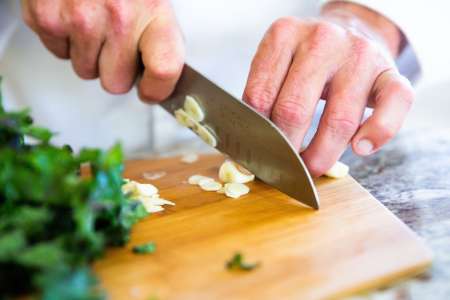 chef slicing garlic