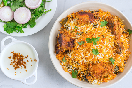 chicken biryani with raita on the side