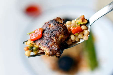 couscous on a spoon with lamb