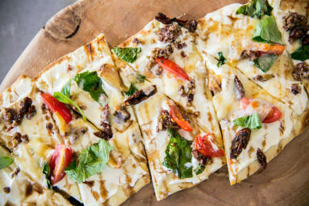 flatbread with white sauce and basil