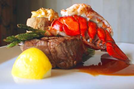 fresh lobster and beef tenderloin steak with saffron sauce and potatoes