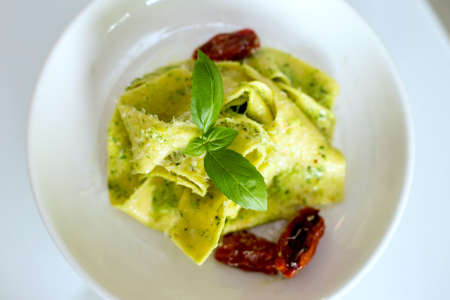 fresh pasta with pesto and sausage