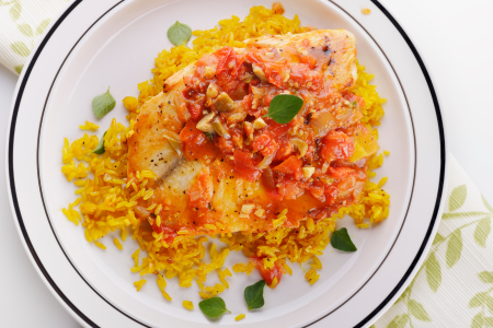 grilled tilapia on african fried rice in sauce