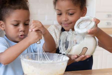 little kids making pizza dough