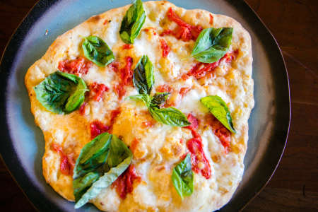pizza with basil and tomatoes