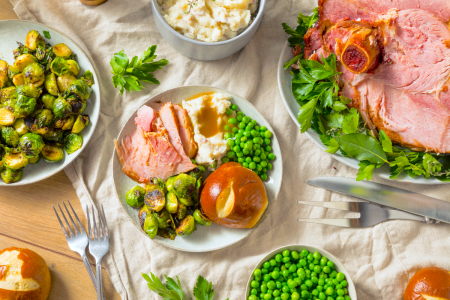 festive holiday menu with baked ham brussels sprouts and dinner rolls