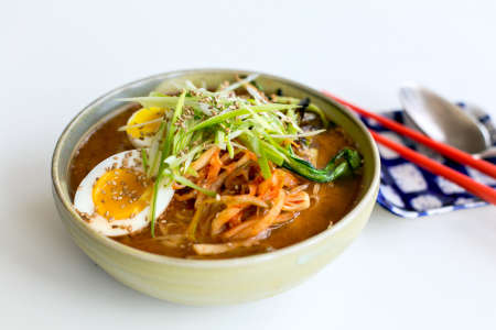 ramen noodle soup with eggs and vegetable toppings