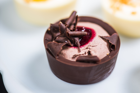 raspberry mousse dessert in a chocolate glass