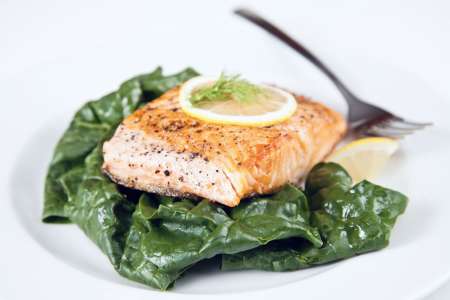 salmon confit on sauteed spinach salad