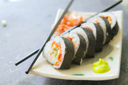 salmon sushi roll with cucumber and avocado