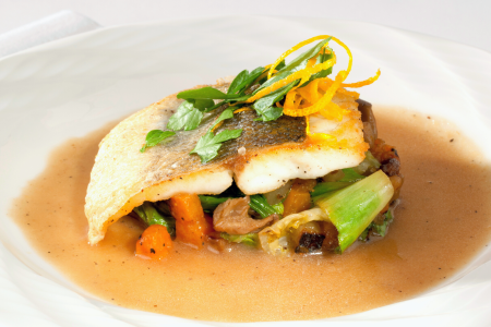 seared branzino with vegetables in shallot puree