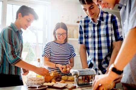 teenage kids making pasta