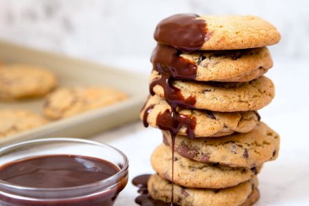 stack of chocolate chip cookies with chocolate sauce