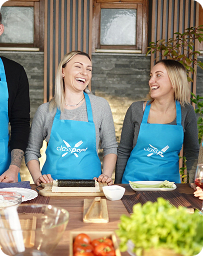 Guests laughing while cooking