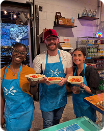 Smiling participants holding finished dishes