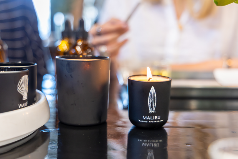 Dallas - Finished scented candles in black containers cooling on the table during a candle workshop Shot