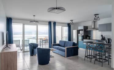 Modern B&B HOME apartment with open kitchen living area and balcony featuring stunning sea views