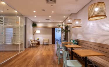 Modern and cozy B&B HOTEL lounge area with wooden furniture and warm lighting for guests to relax