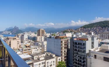 Panoramic city view from a B&B HOTEL balcony overlooking Rio de Janeiro with mountains and the ocean in the background
