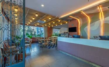 Modern B&B HOTEL lobby with reception desk and cozy seating area featuring elegant decor and warm ambient lighting