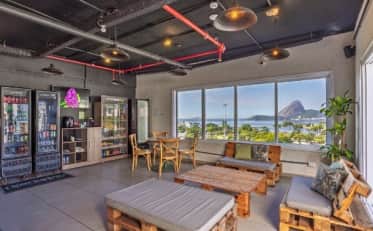 Modern B&B HOTEL lounge area with snack bar and pallet furniture featuring a scenic coastal view of Sugarloaf Mountain