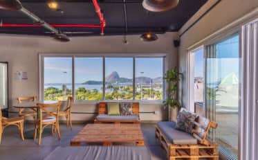 Modern B&B HOTEL lounge area with industrial design and panoramic view of Sugarloaf Mountain in Rio de Janeiro