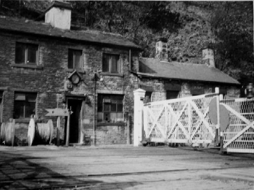 Eastwood Station house and gates at the crossing