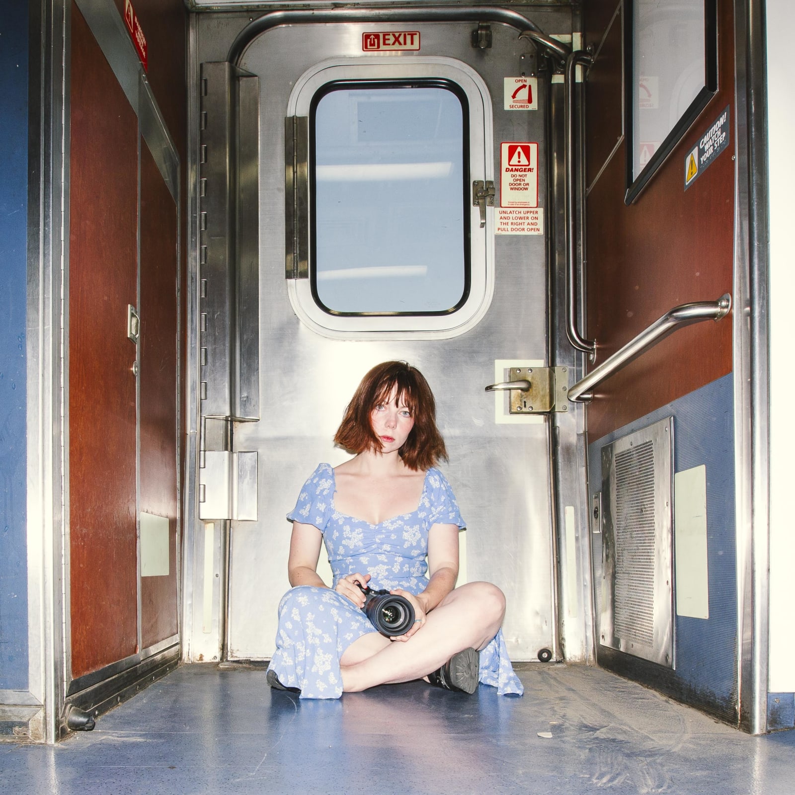 Katie Edwards sitting in front of the train window with her camera in the USA.jpg