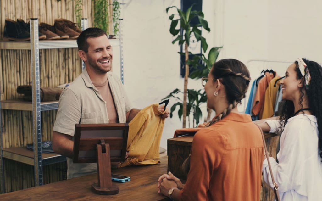 Shop assistant talking to customers