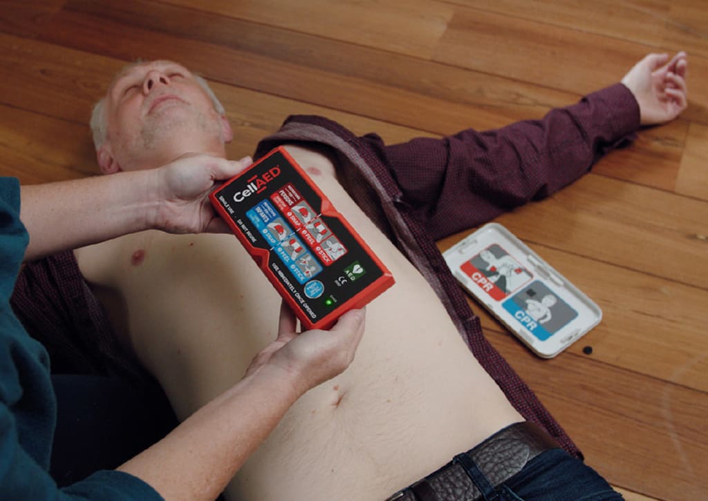 CallAED being administered to a man laying on the ground 