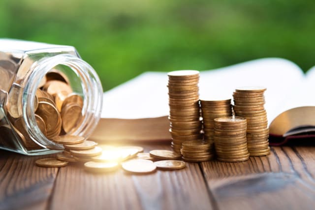 Gold coins and open book on a table