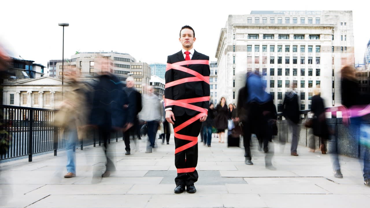 Guy covered in red tape COVER PHOTO
