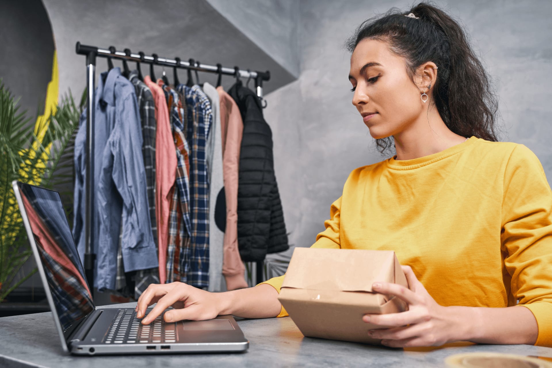 Woman sending parcel using her laptop